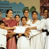 Director Distributing Certificate to Children
